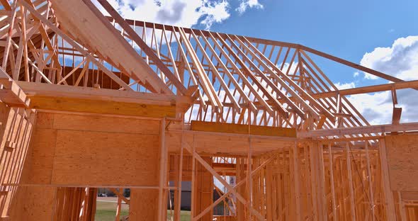 Aerial View a Timber Frame House of Wooden Beam Framework on Stick Built Home Under Construction