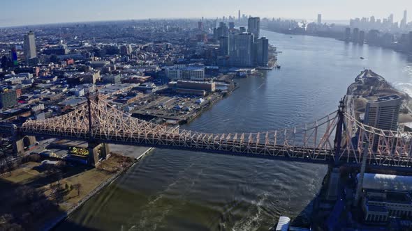 East River Amidst Buildings in City Drone Flying Backward From Skyline