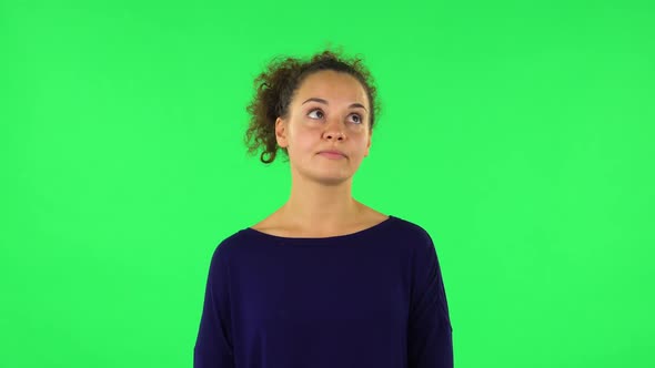 Portrait of Curly Woman Listening Carefully To Boring Information. Green Screen