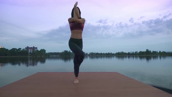 Woman Doing Yoga on Pier.