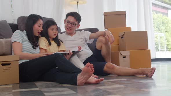 Mom, Dad, and daughter embracing looking forward to future in new home after moving in relocation.
