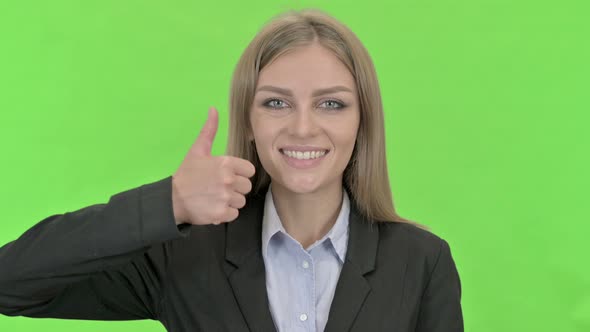 Attractive Businesswoman Showing Thumbs Up Against Chroma Key