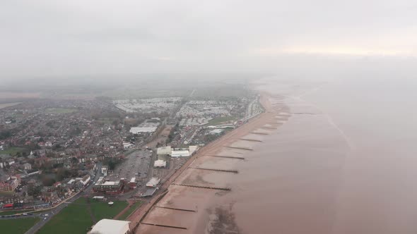 Circling descending drone shot of sea defences on the UK coast