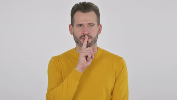 Portrait of Middle Aged Man Showing Quiet Sign By Finger on Lips