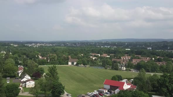 drone pedestal shot up showing a small town.