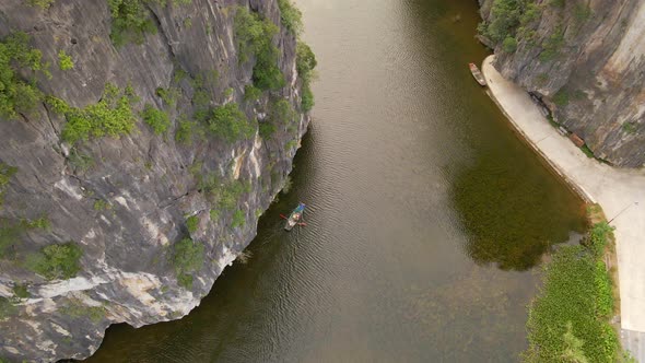 Aerial Shot of Beautiful Limestone Mountains with Passes Carved By a River in Ninh Binh Region a