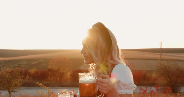 Slavic Lush Girl in Ethnic Dress Poses at Camera with Two Pints of Beer