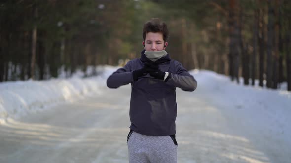 Boy in the Sportswear Doing Exercises Outdoors