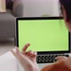Young Asian woman using laptop computer at home with green blank monitor screen. - VideoHive Item for Sale