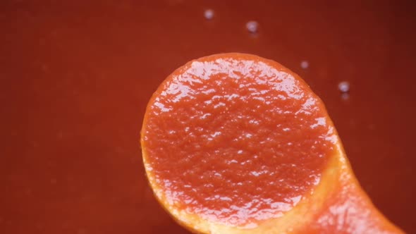 Pouring Tomato Sauce From a Spoon Top View