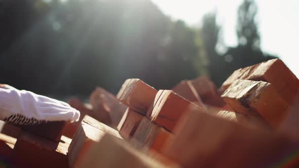 Builder Loader Shifts Bricks Blocks Stacking Red Bricks On A Pallet For Further Transportation