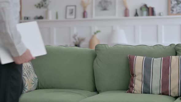 Man Coming Siting on Sofa