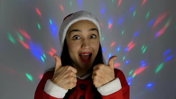 Young Attractive Woman in a New Year Costume Smiles Broadly Against the Background of a Multi