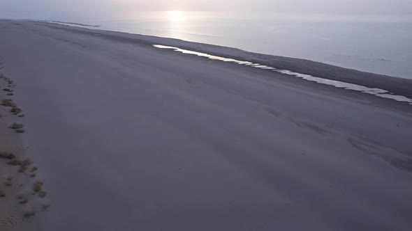 Dawn on the Sandy Beach of the Sea