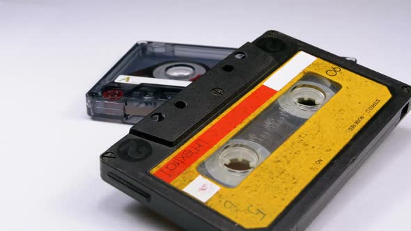 Two Vintage Audio Cassette Rotates on White Background