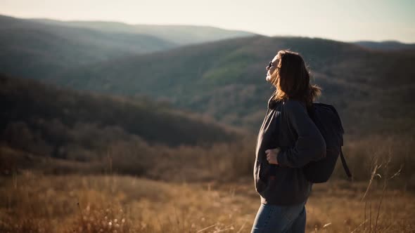 A Young Adult Woman Enjoying Fresh Air and View From the Hill While Trekking