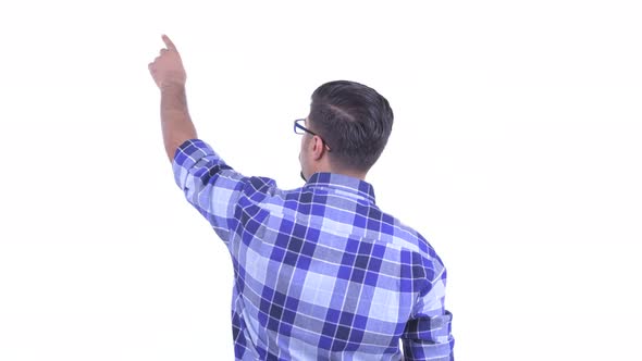 Rear View of Bearded Persian Hipster Man Directing and Pointing Finger