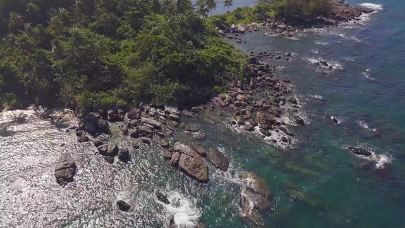 Aerial Fly Over a Rocky Coastal Beach Tropical Island Bay