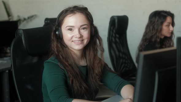 Portrait of happy female Customer Support Specialist working  team Call Center