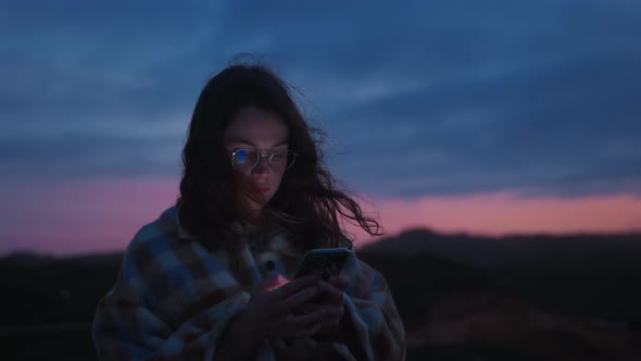 Dreamy Sunset Portrait of Girl Scrolling Her Phone