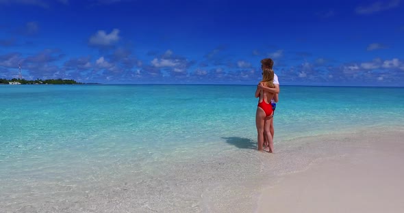 Romantic man and woman married on vacation live the dream on beach on white sand background 