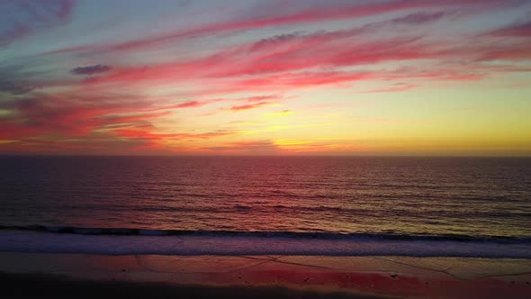 Aerial drone view of a sunset at the beach over the ocean