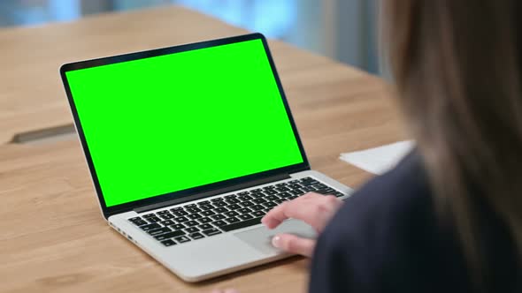 Rear View of Businesswoman using Laptop with Green Chroma Key Screen 