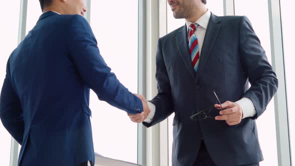 Business People Handshake with Friend at Office