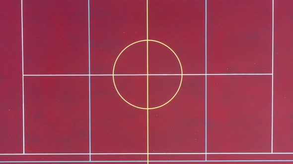 Birds Eye Aerial View of Empty Basketball Field, Lines on Red Court. Rising Top Down Drone Shot