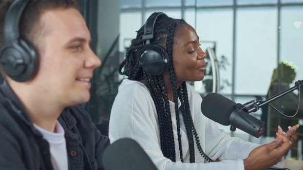 Confident African American Woman With White Man Hosting on Radio Show