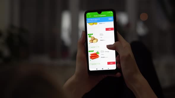 A Woman Orders Food at Home in an Online Store Using Her Smartphone
