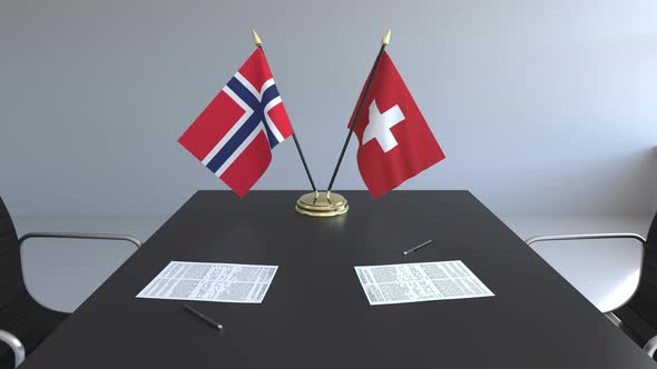 Flags of Norway and Switzerland and Papers