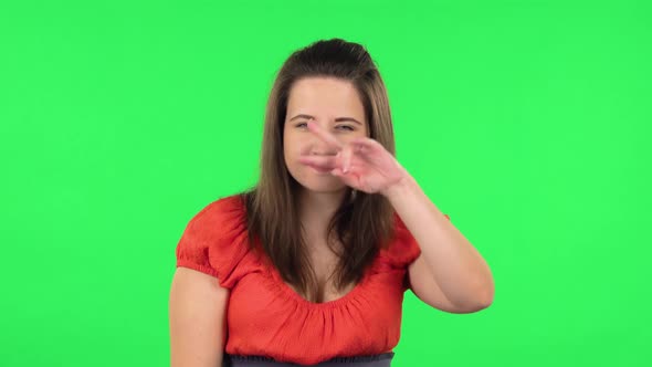 Portrait of Cute Girl Posing for Camera and Making Funny Faces. Green Screen