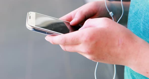 Mid-section of school kid using mobile phone