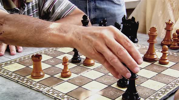 Men playing Chess Outdoors.