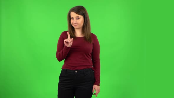 Pretty Girl Seductively Smiling and Gesture Threatens By Shaking Her Index Finger. Green Screen