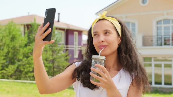 Young Woman Taking Selfie With Lemonade Glass