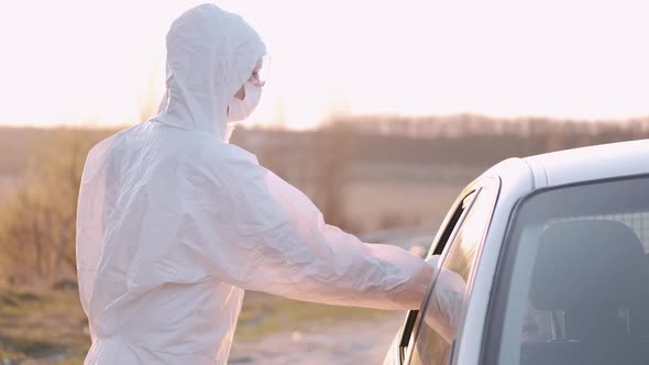 Woman in Protective Equipment Is Checking an Infant Passenger's Temperature