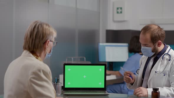 Retired Patient and Doctor with Face Mask Using Greenscreen