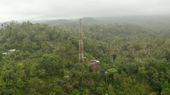 Aerial View of Red and White Radio Tower in Dense Tropical Rainforest