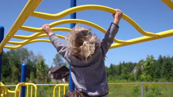 Happy Young Boy on Park Climbing Frame