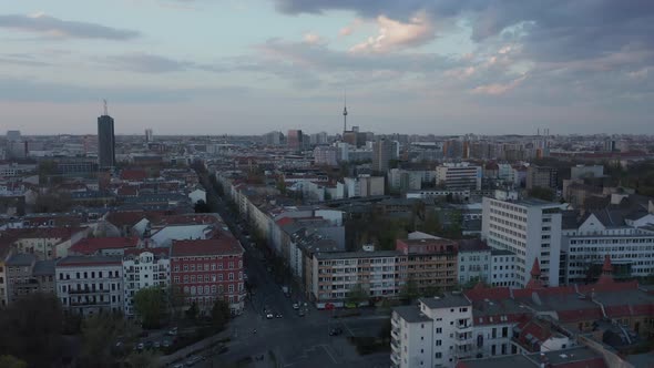 AERIAL: Beautiful Wide View Over Dark Berlin Cityscape During Sunset with Alexanderplatz TV Tower