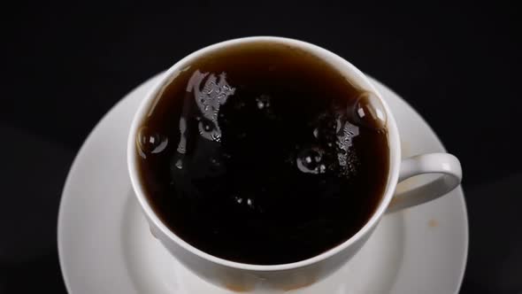 Sugar Cubes Dropped Into Coffee Creating Splash