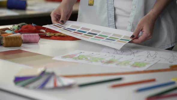 Stylist Examining Palette Choosing Main Color of New Fashion Collection