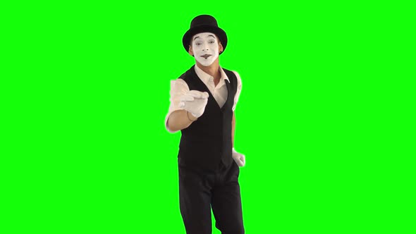 Funny Male Mime with White Face in White and Black Clothes Doing Performance