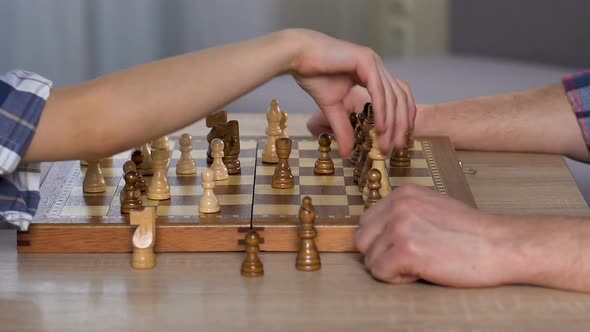 Smart Child Wins Chess, Handshaking With His Proud Father, Chessboard Close Up