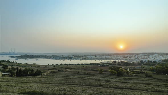 Holy Grail Sunset Timelapse overlooking Marsaxlokk and the Freeport in Malta