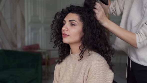 Hairdresser Dries His Client's Hair with a Hair Dryer in a Beauty Salon