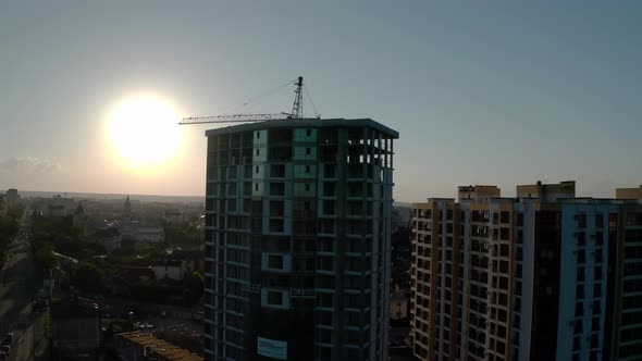 Aerial Drone View of Construction in Sunset Light. Construction Site Building in City. Flying Around