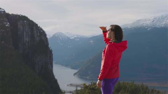 Adventurous Girl Hiking in the Mountains During a Sunny Winter Sunset